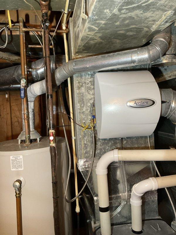 Responded to service call for excessive furnace noise. Upon inspection, identified failed inducer motor assembly causing loud operation during furnace cycles. Replaced defective inducer motor with new OEM unit and verified proper operation. Performed maintenance on Aprilaire humidifier system, including cleaning mineral buildup from water panel and flushing drain line to ensure proper drainage and humidity delivery. Tested all systems for proper operation and confirmed noise issue resolved.