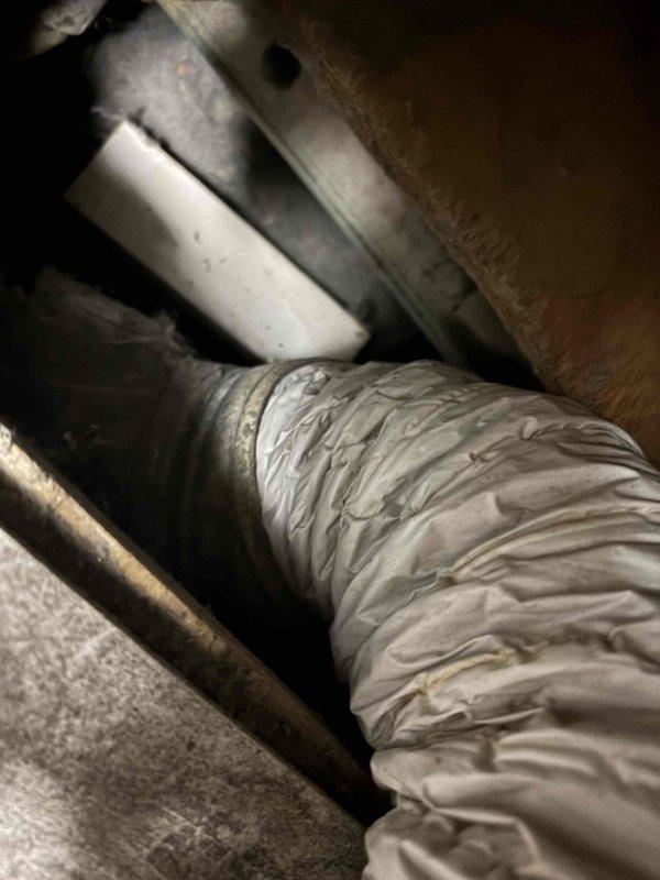 Responded to service call for dryer vent that was repeatedly disconnecting from overhead ductwork. Upon inspection, found the flexible dryer vent hose was inadequately secured and lacked proper extension to maintain a stable connection to the main ductwork system in the attic space. Extended the dryer vent run using additional flexible insulated ductwork to ensure proper reach and eliminate tension on the connection point. Secured all duct connections with appropriate fasteners and verified proper routing through the ceiling penetration. Ensured the insulated flexible duct was properly supported and sealed at the junction point to prevent future disconnection. Tested the installation to confirm secure attachment and proper airflow pathway from dryer to exterior vent termination.