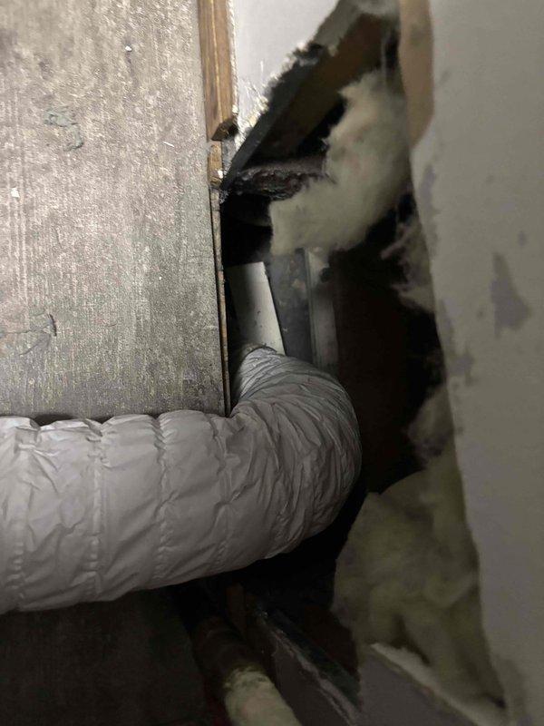 Responded to service call for dryer vent that was repeatedly disconnecting from overhead ductwork. Upon inspection, found the flexible dryer vent hose was inadequately secured and lacked proper extension to maintain a stable connection to the main ductwork system in the attic space. Extended the dryer vent run using additional flexible insulated ductwork to ensure proper reach and eliminate tension on the connection point. Secured all duct connections with appropriate fasteners and verified proper routing through the ceiling penetration. Ensured the insulated flexible duct was properly supported and sealed at the junction point to prevent future disconnection. Tested the installation to confirm secure attachment and proper airflow pathway from dryer to exterior vent termination.