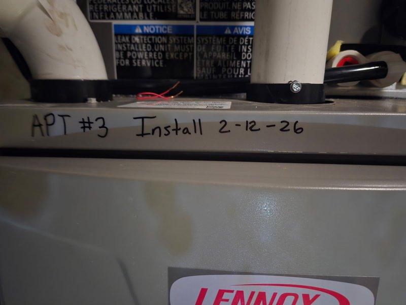 Responded to callback for recurring system leak at apartment unit #3. Upon arrival, found significant water accumulation on concrete floor beneath HVAC equipment, with extensive rust-colored staining indicating ongoing moisture issue. Documented active leak condition with photographs showing water damage pattern and affected Lennox furnace/air handler unit. System requires further diagnostic work to identify and repair leak source.
