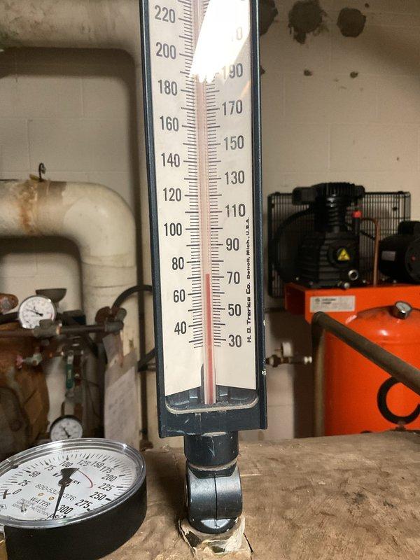 Responded to no hot water complaint affecting third floor tenants. Upon arrival, accessed mechanical room and inspected boiler system and associated components. Found expansion tank showing significant deterioration with compromised insulation and surface degradation. Verified system temperature and pressure readings using existing gauges. Inspected connected piping, valves, and circulation components for proper operation. Documented equipment condition including analog thermometer readings and pressure gauge status. System components showed age-related wear consistent with older installation. Identified issues contributing to inadequate heat distribution to upper floors and provided recommendations for equipment replacement and system maintenance to restore proper hot water service to affected areas.