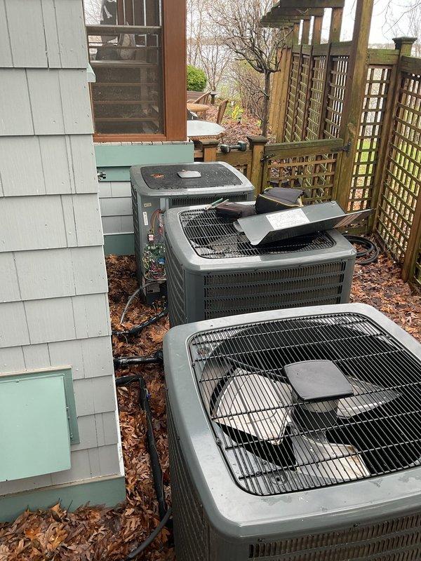 Responded to no-cooling complaint on master bedroom A/C unit following recent clean and check service. Upon arrival, confirmed indoor fan operation but no cooling output. Inspected outdoor condenser unit and reviewed diagnostic fault code chart to identify system malfunction. Photographed diagnostic reference panel showing LED error code descriptions and documented multiple outdoor condensing units installed at property for service records.