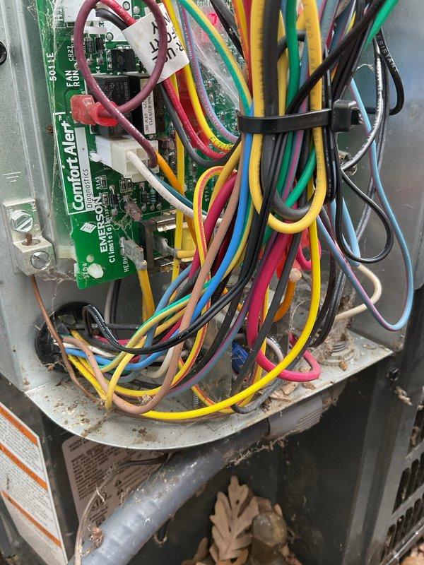 Installed low ambient control kit on outdoor condensing unit to enable system operation during cooler outdoor temperatures. Mounted ComfortAlert circuit board inside control panel, wired control module to existing capacitor and electrical components, and secured all connections with appropriate wire nuts and cable management. System tested and verified operational with new low ambient control functioning properly.