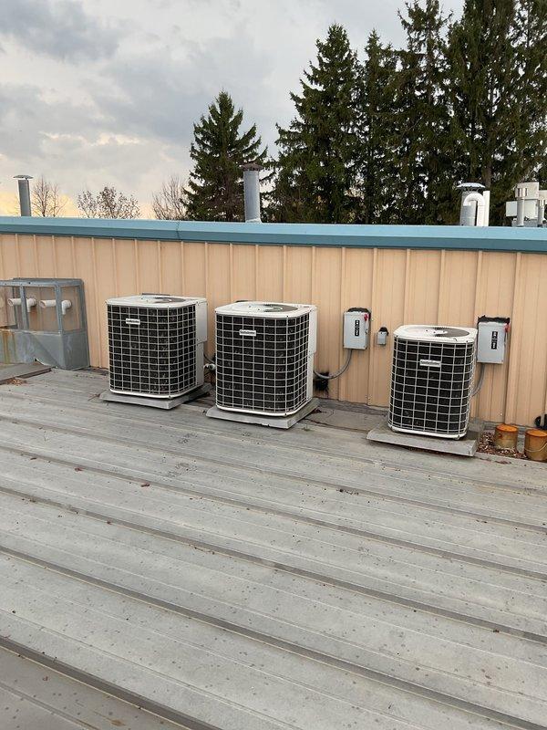 Responded to service call for non-operational air conditioning system with water discharge from furnace cabinet. Upon arrival, inspected multiple outdoor condenser units and indoor air handler assembly. Identified condensate drain blockage causing water overflow from furnace main body. Cleared obstruction from condensate line, verified proper drainage flow, and tested system operation. All three condenser units (#3 marked units) confirmed operational with proper refrigerant flow and electrical connections secure at disconnect boxes. System restored to normal cooling operation with no further water leakage observed.