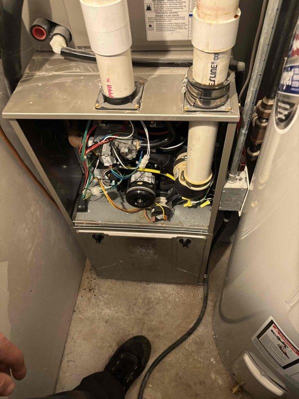Responded to service call for reported gas odor at furnace. Performed comprehensive safety inspection of heating system, checking all gas connections, heat exchanger integrity, and combustion components. Measured supply and return air temperatures, which registered 148.2°F, indicating proper heat rise within manufacturer specifications. Conducted thorough clean and check maintenance on both furnace and air conditioning systems, including inspection of blower motor, electrical connections, condensate drainage system, and all safety controls. Verified proper venting through PVC exhaust and intake pipes. All gas connections tested with no leaks detected, system operating safely within normal parameters.