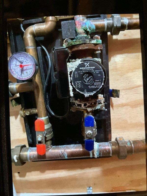 Performed comprehensive clean and check service on residential heating system, air conditioning unit, and boiler. Furnace and air conditioner inspected and found operating within normal parameters with no issues detected. Boiler inspection revealed active leak at manifold pipe connection with significant corrosion, mineral buildup, and oxidation present throughout copper piping and fittings. Circulation pump assembly showing advanced deterioration with white scale deposits and green patina on copper components. Recommended replacement of corroded manifold pipe, boiler sensor, and exhaust port to restore proper system operation and prevent further damage.
