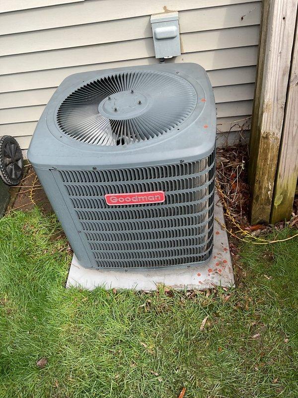 Responded to no cooling complaint on first use of season for Goodman air conditioning system. Customer had already replaced furnace filter prior to arrival. Performed exterior coil cleaning by rinsing down condenser unit to remove accumulated debris. Tested contactor relay operation and confirmed proper functionality. Measured refrigerant charge and found system running low. Added refrigerant to bring system to proper operating levels and verified cooling operation restored.