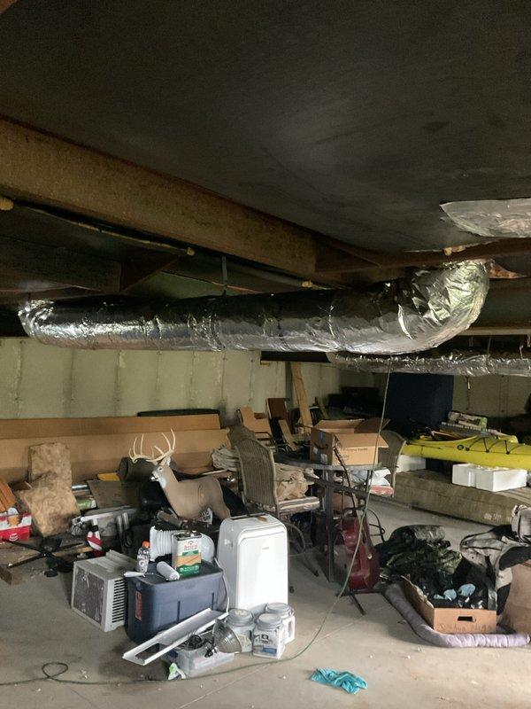 Completed installation of supply ductwork runs in basement area, including proper routing of flexible duct through floor joists and application of foil-wrapped insulation to all new supply lines. All ductwork was secured to structural members and insulated to code specifications to ensure proper airflow and energy efficiency throughout the system.