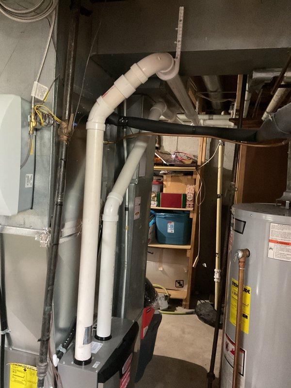 Installed approximately 30 feet of 2-inch PVC piping with necessary fittings to extend existing vertical condensate drain line from furnace. The existing vertical run from the furnace was already PVC, which was connected to the new horizontal routing that terminates at the building exterior with proper termination cap.
