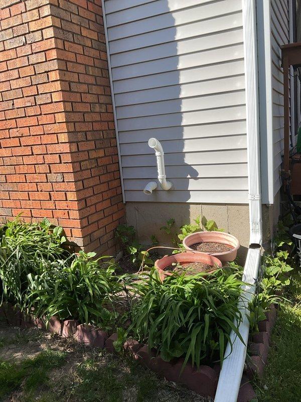 Installed approximately 30 feet of 2-inch PVC piping with necessary fittings to extend existing vertical condensate drain line from furnace. The existing vertical run from the furnace was already PVC, which was connected to the new horizontal routing that terminates at the building exterior with proper termination cap.