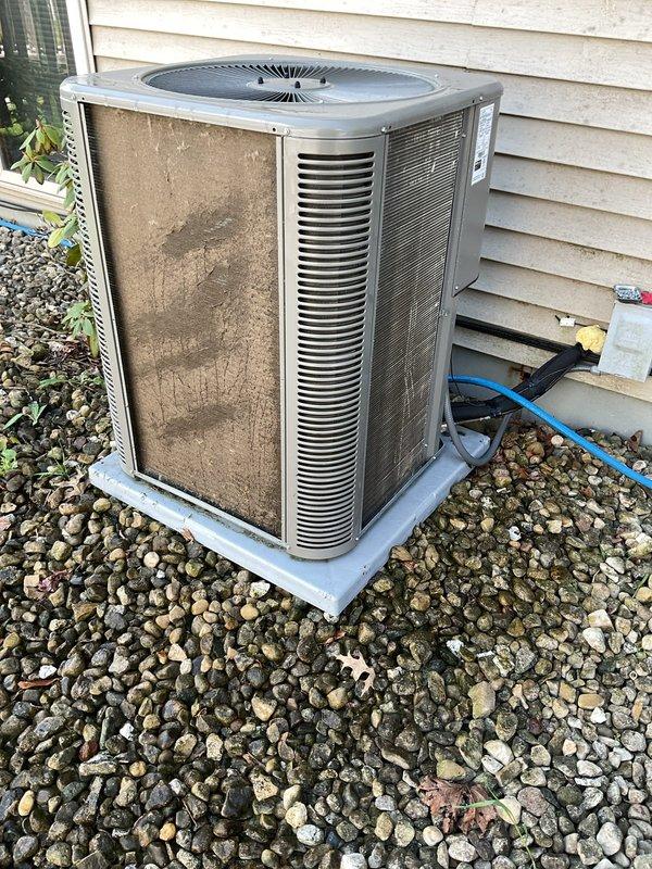 Performed comprehensive AC clean and check on outdoor condenser unit. Unit exterior and coils were found to be very dirty with significant dirt accumulation and discoloration throughout. Thoroughly cleaned condenser coils, cabinet panels, and all accessible components. Refrigerant charge was measured and found to be slightly high; adjusted to manufacturer specifications. Completed full system inspection and operational verification.