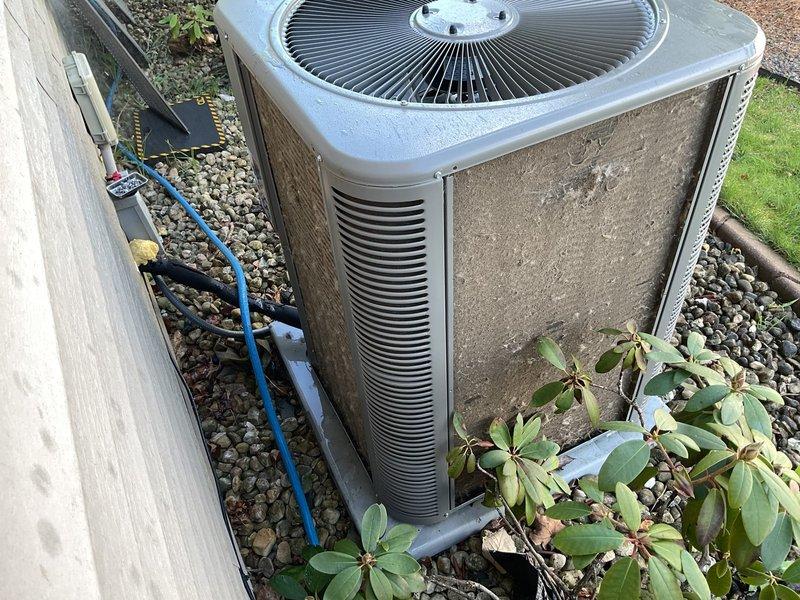 Performed comprehensive AC clean and check on outdoor condenser unit. Unit exterior and coils were found to be very dirty with significant dirt accumulation and discoloration throughout. Thoroughly cleaned condenser coils, cabinet panels, and all accessible components. Refrigerant charge was measured and found to be slightly high; adjusted to manufacturer specifications. Completed full system inspection and operational verification.