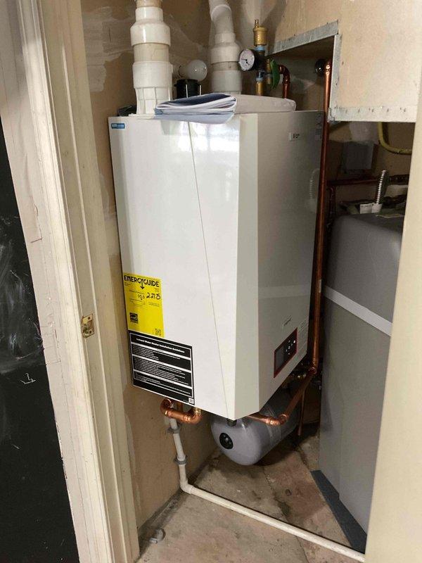 Responded to no heat and no hot water call on tankless boiler system displaying "Outside sensor open" error code. Upon inspection, identified failed flow switch and incorrect system settings preventing both central heating and domestic hot water production. Reset system parameters and adjusted boiler configuration to restore central heating operation. Flow switch failure confirmed as cause of domestic hot water loss. Customer advised that complete system replacement required to restore full hot water functionality, as current unit unable to provide domestic hot water due to failed components and system limitations.