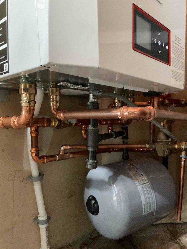 Responded to no heat and no hot water call on tankless boiler system displaying "Outside sensor open" error code. Upon inspection, identified failed flow switch and incorrect system settings preventing both central heating and domestic hot water production. Reset system parameters and adjusted boiler configuration to restore central heating operation. Flow switch failure confirmed as cause of domestic hot water loss. Customer advised that complete system replacement required to restore full hot water functionality, as current unit unable to provide domestic hot water due to failed components and system limitations.