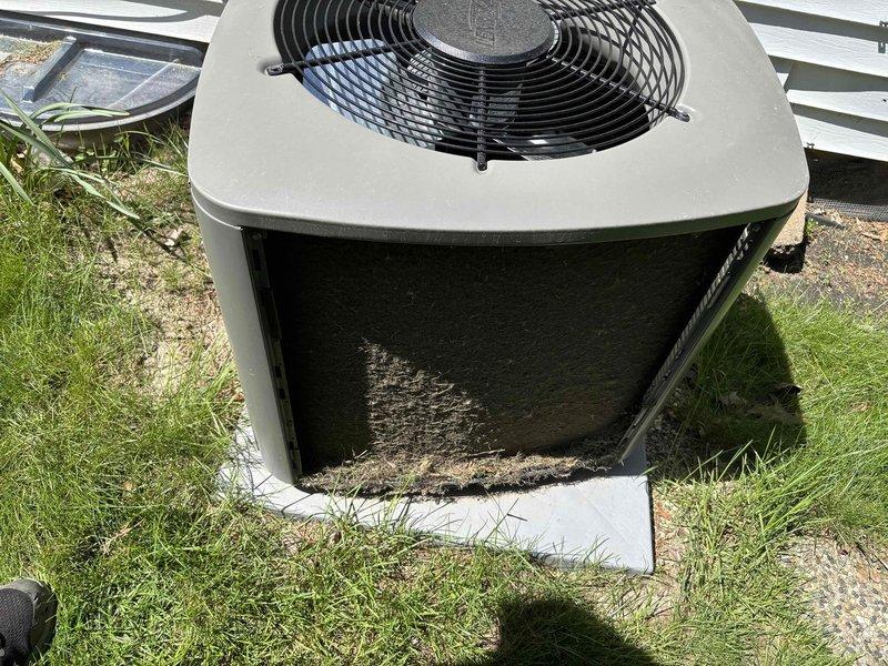 Completed scheduled air conditioning maintenance and inspection on Lennox outdoor condensing unit. Performed comprehensive clean and check service including visual inspection of cabinet, fan assembly, and electrical components. Unit showed signs of extended exposure and accumulation of dirt and debris on exterior panels and base. Cleaned condenser coils, removed organic material and debris from unit base and surrounding pad area. Verified proper operation of condenser fan motor and compressor. Checked electrical connections at disconnect box and confirmed secure conduit routing. Inspected refrigerant lines for damage or deterioration. System tested and operating within normal parameters. Maintenance complete with no deficiencies noted requiring immediate attention.