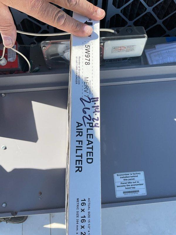 Responded to complaint of inadequate cooling in building. Upon inspection, found thermostat set too high and ventilation system creating excessive negative pressure. Adjusted thermostat to proper setpoint and disabled unnecessary ventilation to correct building pressurization. Inspected air filtration system and noted MERV 8 filters dated 2024 in acceptable condition. Examined outdoor condensing unit and confirmed operational status. System now cooling properly and scheduled for full preventive maintenance service.