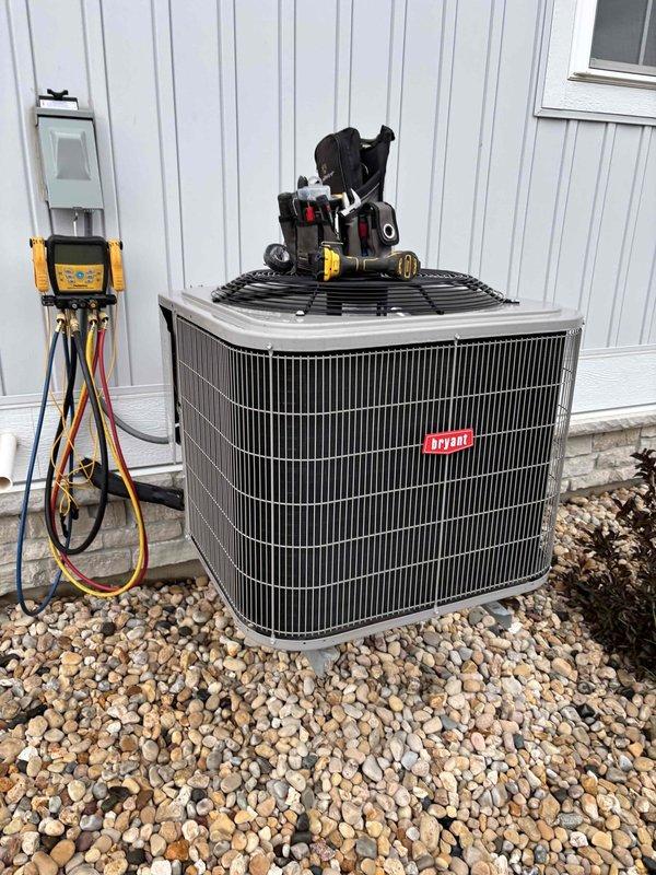 Completed annual maintenance and tune-up on Bryant air conditioning system. Performed thorough cleaning and inspection of outdoor condenser unit, verified all electrical connections, and tested system performance with digital temperature measurements showing proper operation with supply air at 84.4°F and return air at 103.3°F. All components found to be functioning within normal parameters with no issues identified.