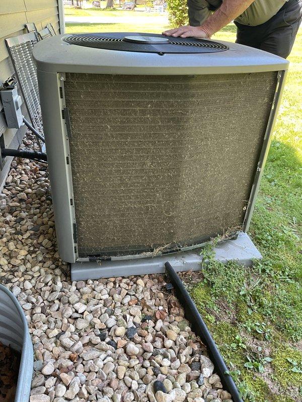 Performed preventative maintenance inspection and cleaning on a two-year-old residential air conditioning system in preparation for cooling season. Upon arrival, conducted thorough examination of outdoor condenser unit, which showed significant accumulation of dirt, dust, and debris throughout the condenser coils and fins despite relatively new equipment age. Removed access panels to assess internal components and coil condition. Performed complete cleaning of condenser coils to remove heavy buildup that had collected across the finned surfaces, restoring proper airflow and heat transfer efficiency. Verified all mechanical components, electrical connections, and refrigerant lines were in good working order with no deficiencies noted. Unit operational status confirmed satisfactory with no repairs required at this time.