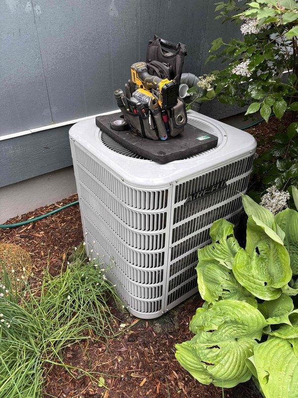Completed scheduled AC clean and check maintenance on residential outdoor condensing unit. Performed comprehensive system diagnostics using digital testing instruments to verify electrical parameters and operational performance. All measurements indicated normal operating conditions with no issues identified. System operating properly upon completion of preventive maintenance service.