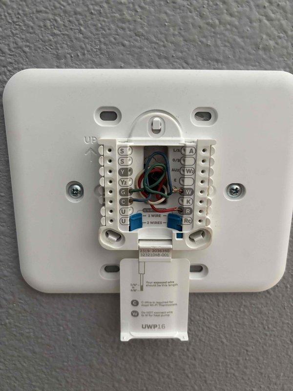 Responded to no-cooling complaint on recently installed air conditioning system. Upon arrival, confirmed thermostat fan operation but compressor would not engage. Diagnosed missing C-wire adapter as cause of insufficient power to thermostat for proper system communication. Installed C-wire adapter at equipment, connected wiring to appropriate terminals, and verified proper voltage supply. Tested system operation with supply air temperature reading of 49.1°F, confirming compressor engagement and adequate cooling performance. System restored to full functionality.