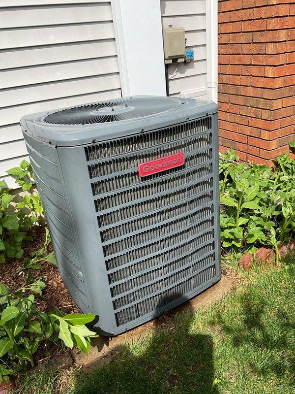 Completed seasonal clean and check on older Goodman condensing unit. Performed thorough inspection of all accessible components, cleaned condenser coil, verified proper operation of fan motor and compressor, and confirmed unit is functioning within normal parameters. Unit appears well-maintained with adequate clearance and proper installation on concrete pad.