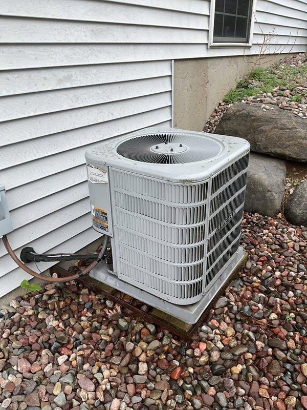 Responded to service call for residential air conditioning system not producing cold air. Upon inspection, found condenser unit operational with fan running but insufficient cooling output. Diagnosed system as low on refrigerant charge. Added refrigerant to manufacturer specifications and performed cleaning of condensing coil to restore proper heat transfer efficiency. System tested and confirmed returning to normal cooling operation upon completion.