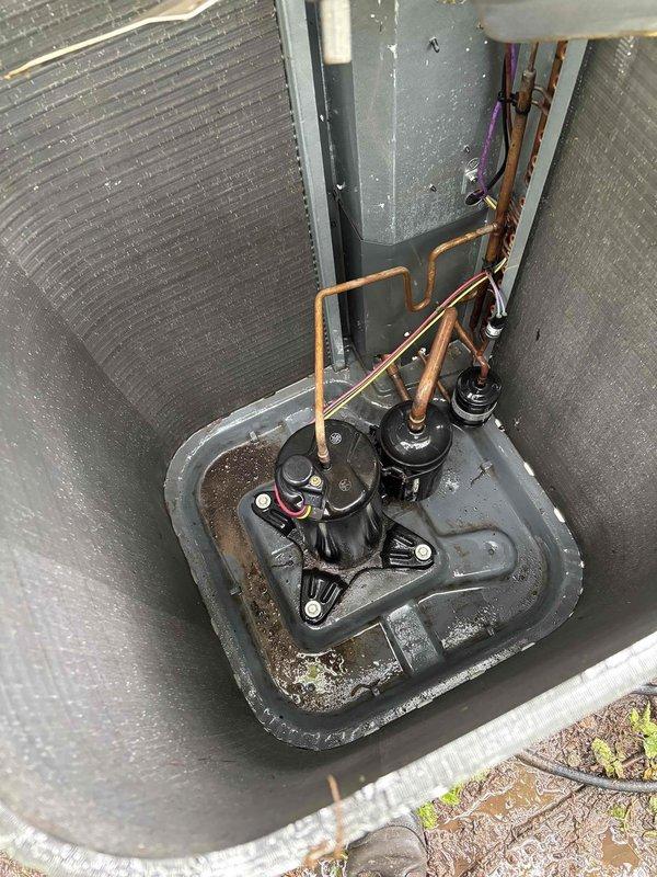 Performed comprehensive air conditioning clean and check service. Found condenser coil heavily soiled with dirt and debris accumulation, restricting airflow and reducing system efficiency. Thoroughly cleaned condenser coil to restore proper heat transfer capability. Diagnostic testing revealed low refrigerant charge in the system. Added 1 pound of R-410A refrigerant to bring system to proper operating levels. Verified system pressures and temperatures after charging. Inspected drain pan and found typical debris accumulation; unit now operating within manufacturer specifications.