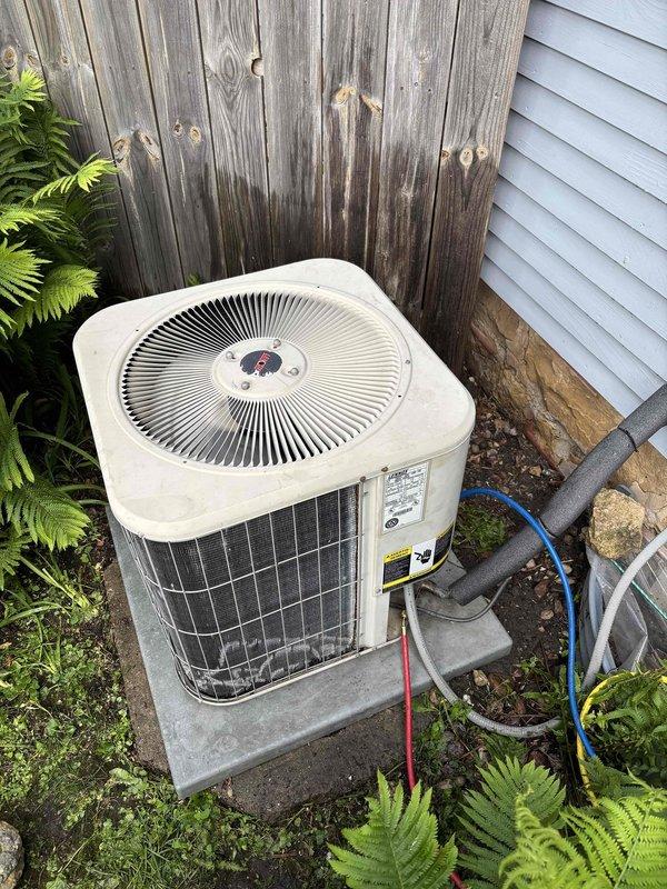 # HVAC Maintenance Completed

Performed comprehensive air conditioning clean and check on outdoor condensing unit. Upon inspection, found heavily soiled condenser coil with significant debris accumulation and a clogged condensate drain line restricting proper drainage.

Removed top panel to access internal components and thoroughly cleaned the outdoor condenser coil to restore proper airflow and heat transfer efficiency. Cleared the obstructed drain hose to ensure proper condensate removal and prevent potential water damage or system shutdown. Unit tested and operating within normal parameters upon completion.
