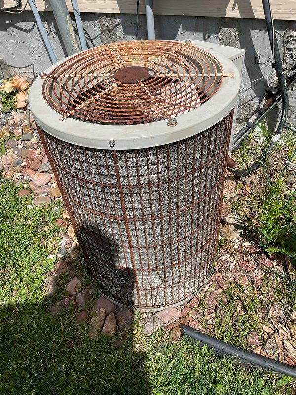 Responded to no cooling complaint on residential air conditioning system. Upon arrival, found heavily corroded outdoor condenser unit with significant rust deterioration on exterior grille and cabinet, indicating advanced age and weathering. System evaluation confirmed unit was inoperative and beyond economical repair. Assessed refrigerant lines and ductwork components. Determined complete system replacement necessary due to age, condition, and failure to provide adequate cooling. Recommended new air conditioning installation to restore comfort and efficiency.