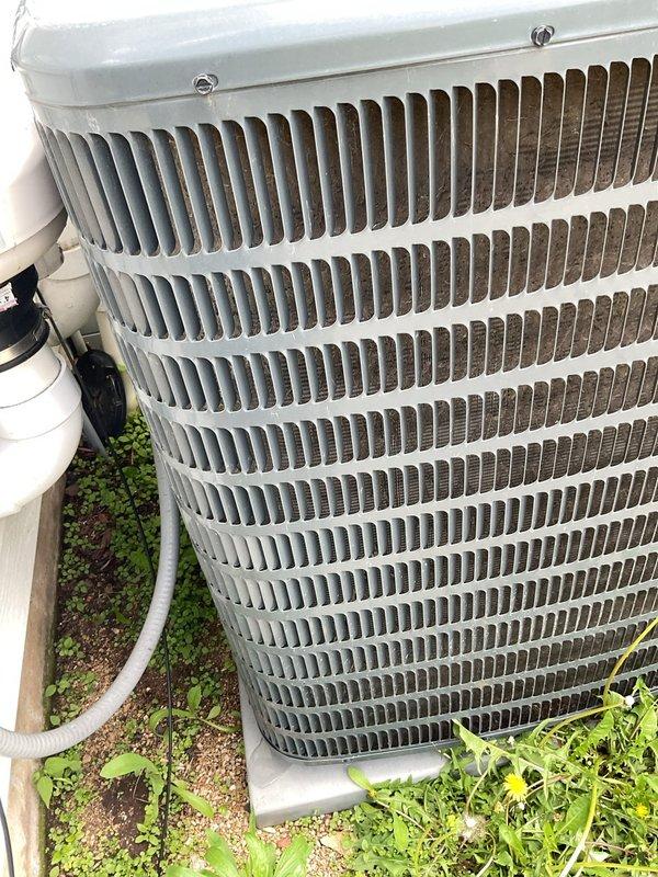 Responded to no-cooling complaint with reported humming noise from HVAC system. Upon inspection, diagnosed failed blower motor with locked rotor preventing air circulation. Evaluated indoor furnace unit and identified significant heat exchanger corrosion presenting safety concerns. Documented existing outdoor condenser unit condition showing normal operational wear and debris accumulation on coil fins. Recommended complete furnace replacement due to compromised heat exchanger integrity and blower motor failure.