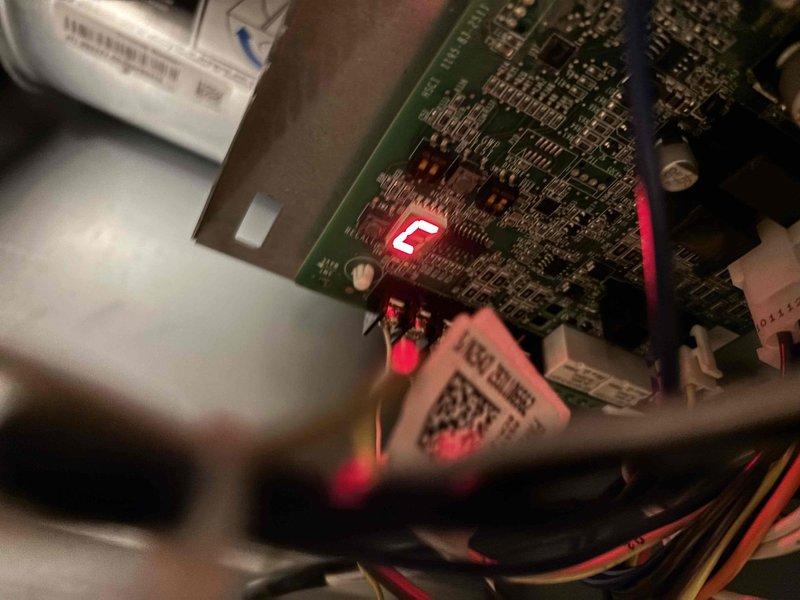 Responded to no-cool call on recently installed Lennox HVAC system under warranty. Upon inspection, found control board displaying error code "E" via LED indicator. Diagnosed wiring issue affecting system startup and corrected switched wire connections to restore proper operation and cooling functionality.