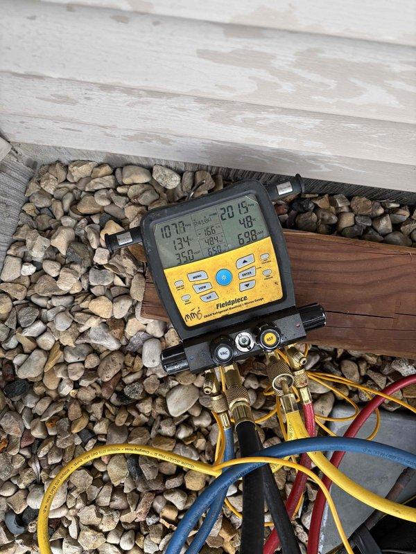 Performed annual air conditioning clean and check maintenance on residential condensing unit. Connected manifold gauges and testing equipment to verify system pressures and temperatures, confirming all operating parameters within normal specifications. Unit found to be operating properly with no issues identified.