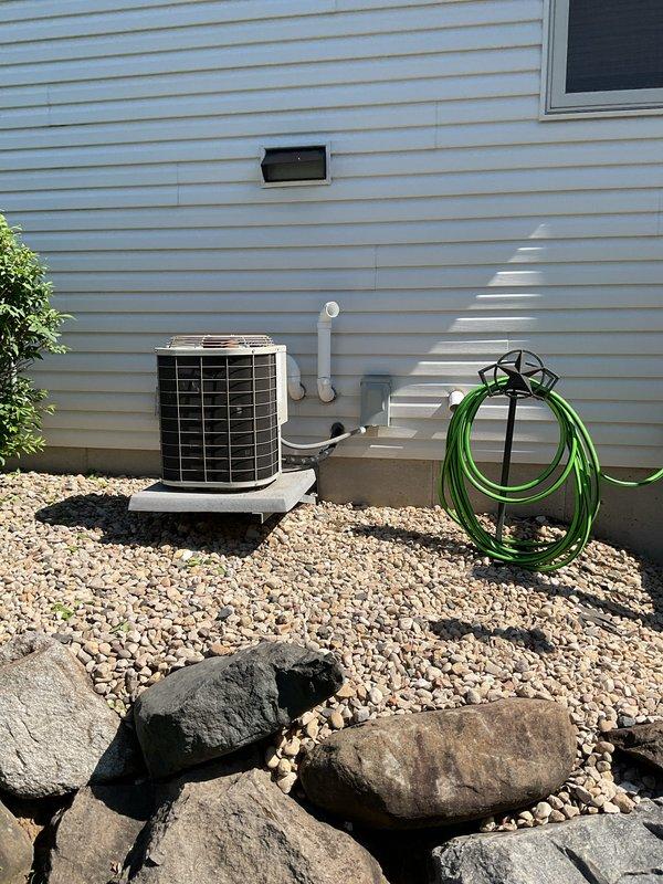 Responded to no cooling complaint on residential air conditioning unit. Upon inspection, discovered rodent damage to electrical wiring causing short circuit against cabinet housing. Repaired damaged wire using butt connector and properly insulated with electrical tape. Restored power to unit and performed operational testing, which revealed failed start capacitor reading below specification. Replaced defective start capacitor and verified system returned to normal cooling operation.
