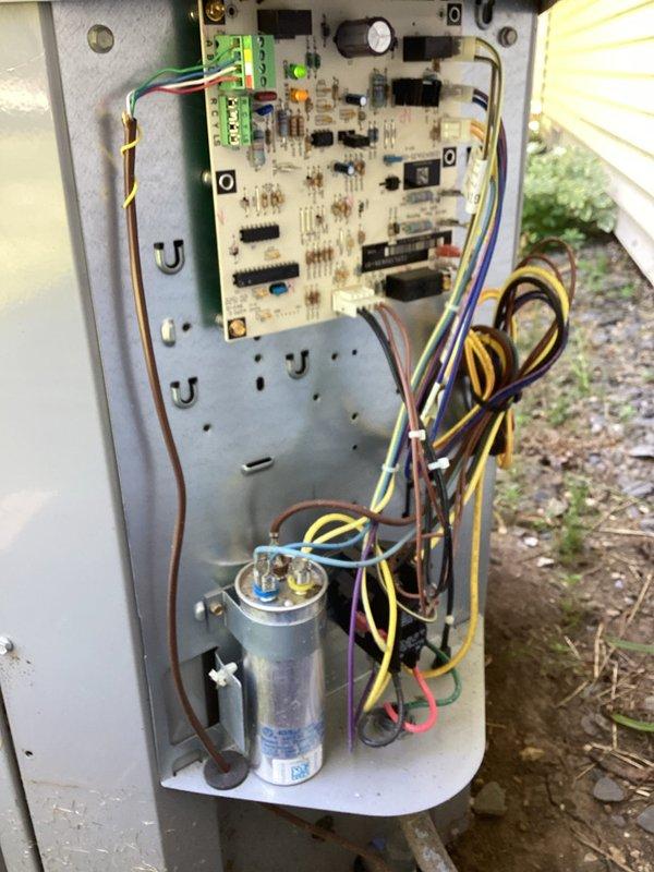 Completed annual tune-up on outdoor HVAC unit. Accessed control panel and electrical compartment to inspect circuit board, capacitor, and wiring connections. Cleaned accumulated dirt and debris from condenser coils and protective grille. All electrical components, terminal connections, and capacitor verified in proper working condition. Unit operational and ready for continued service.