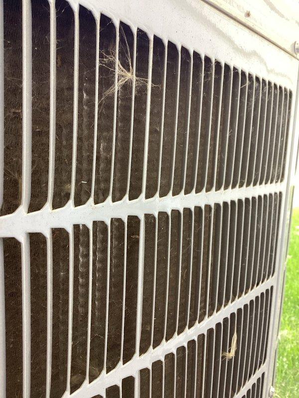 Completed annual tune-up on outdoor HVAC unit. Accessed control panel and electrical compartment to inspect circuit board, capacitor, and wiring connections. Cleaned accumulated dirt and debris from condenser coils and protective grille. All electrical components, terminal connections, and capacitor verified in proper working condition. Unit operational and ready for continued service.