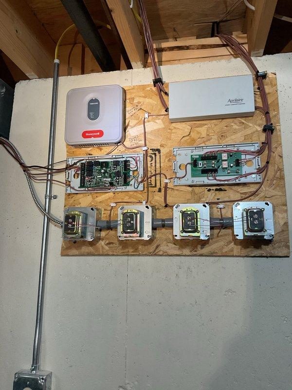 Responded to service call for malfunctioning zone control system where only one floor would cool at a time, requiring manual thermostat switching between upper and lower zones. Upon inspection, diagnosed issue with zone control panel and damper coordination. Inspected dual-zone control system including THMS220R and THM3320R zone controllers, verified wiring connections at terminal blocks, and tested communication between thermostats and zone dampers. Recalibrated zone control settings to allow simultaneous operation of both zones. Performed complete system clean and check including inspection of all electrical connections, circuit boards, and control panels. Verified proper operation of Honeywell and Aprilaire components. Tested system operation across both zones to confirm proper cooling functionality and thermostat response. System restored to normal multi-zone operation with both floors cooling independently as designed.