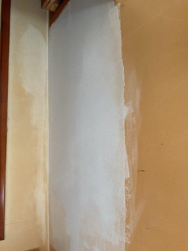 Completed drywall repair on ceiling damaged during attic access by technician. Removed compromised ceiling material, ground out affected plaster and fiberglass mesh, applied multiple coats of joint compound over three separate visits with intermediate sanding between applications, performed final sanding, and primed repaired area with primer paint to prepare surface for finish coating.