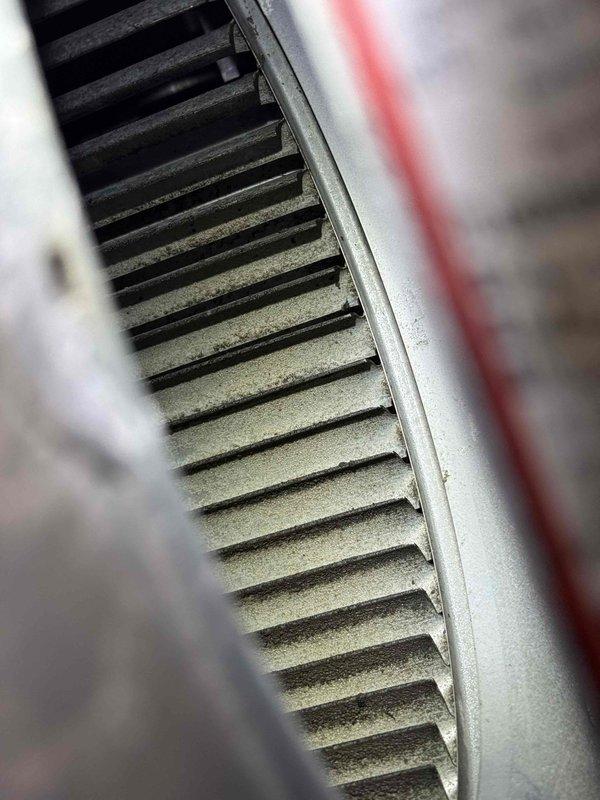 Performed comprehensive cleaning service on mobile home furnace system due to heavily soiled components affecting airflow and efficiency. Evaporator coil exhibited significant dust and debris accumulation with visible frost buildup on metal surfaces, indicating restricted airflow and potential temperature differential issues. Blower motor and housing showed extensive dirt contamination on all surfaces. Utilized shop vacuum and specialized coil cleaner to thoroughly clean evaporator coil fins and blower motor assembly, removing all accumulated dust, dirt, and debris. System components restored to proper operating condition with improved airflow capability.