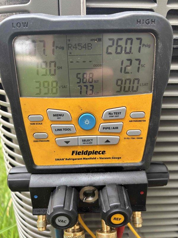 Performed seasonal start-up on recently installed air conditioning system. During inspection, discovered a leaking 3/4" copper street 90 fitting in basement. Unsweat the defective fitting, cleaned joint surfaces, and resoldered connection to eliminate refrigerant leak. Verified system pressures and temperatures using manifold gauges, confirmed proper refrigerant charge, and ensured all connections were secure and leak-free.
