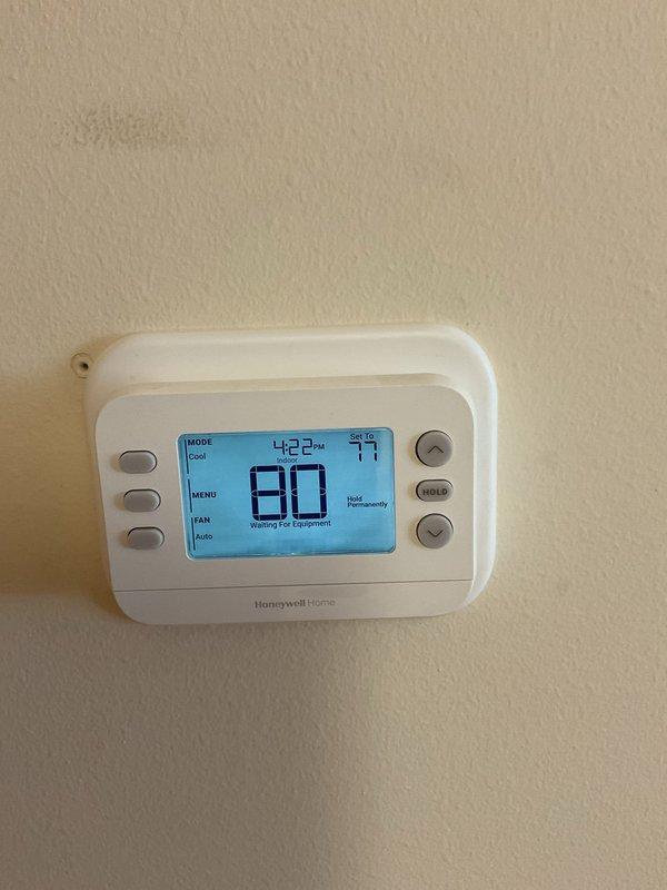 Replaced obsolete Robert Shaw mechanical thermostat with new Honeywell Home digital programmable thermostat on Trane HVAC system. Removed old thermostat, installed new unit, verified proper wiring connections, and tested system operation in cooling mode. System responding correctly to temperature setpoints and functioning as expected.