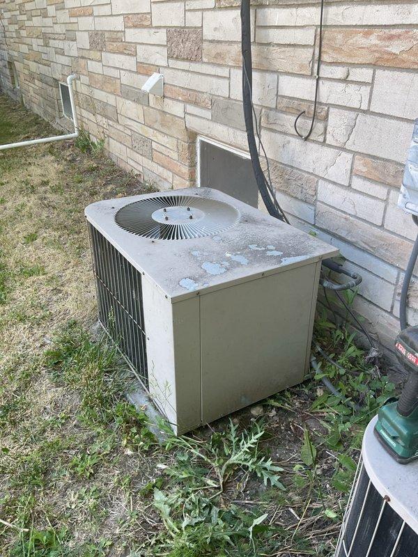 Responded to no-cooling complaint at duplex property. Inspected 26-year-old outdoor condensing unit and found compressor failure with complete loss of refrigerant charge. Accessed second-floor air handler located in attic crawl space and documented deteriorated ductwork with significant material degradation and peeling insulation. Due to age of equipment, catastrophic compressor failure, and loss of refrigerant, recommended complete system replacement rather than repair.