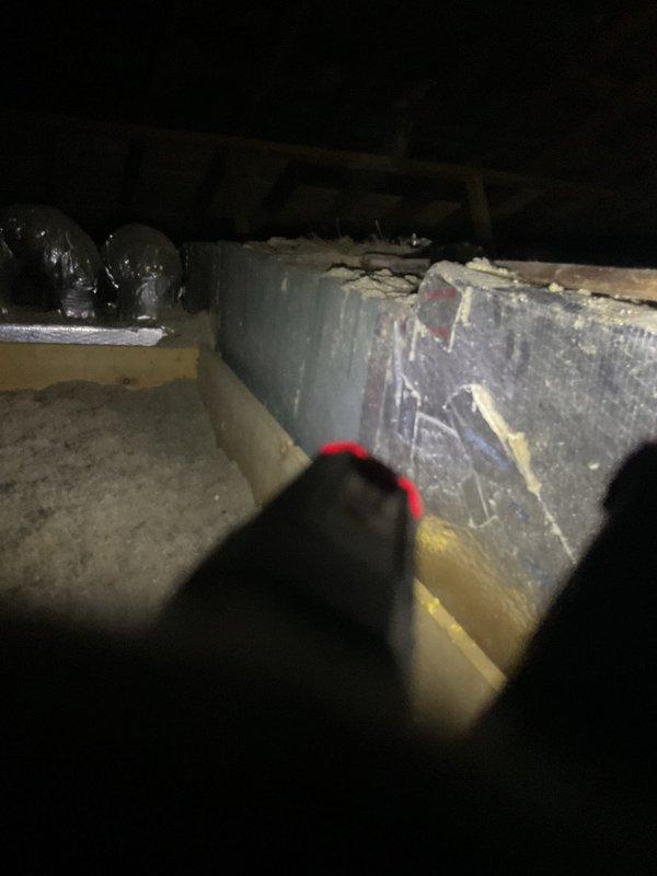 Responded to no-cooling complaint at duplex property. Inspected 26-year-old outdoor condensing unit and found compressor failure with complete loss of refrigerant charge. Accessed second-floor air handler located in attic crawl space and documented deteriorated ductwork with significant material degradation and peeling insulation. Due to age of equipment, catastrophic compressor failure, and loss of refrigerant, recommended complete system replacement rather than repair.