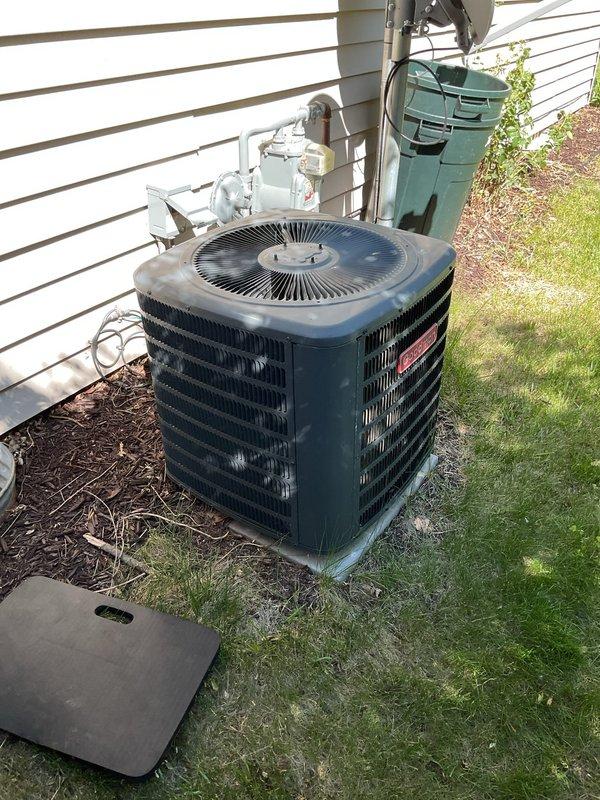 Responded to no cooling complaint on residential air conditioning system. Upon arrival, found outdoor condenser unit with heavily soiled coil fins containing significant accumulation of dirt, dust, debris, and organic matter lodged between fins. Performed exterior coil cleaning by rinsing unit to remove buildup and restore proper airflow. After cleaning and attempting startup, diagnosed failed hermetic compressor capacitor preventing unit operation. Contacted customer for authorization to proceed with repair. Replaced defective capacitor with new component. Conducted operational testing following repair. Verified compressor startup, confirmed proper system operation, and validated cooling performance. Customer reported fresh filter already installed at furnace. Unit restored to normal cooling operation.