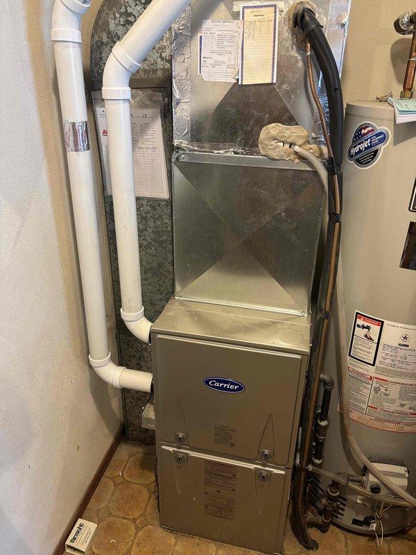 Performed comprehensive furnace clean and check on Carrier residential heating unit. Discovered and replaced heavily soiled air filter that was restricting airflow. Identified surface rust present inside furnace cabinet, which was documented and noted for monitoring. Completed full system inspection and cleaning per standard maintenance protocol.