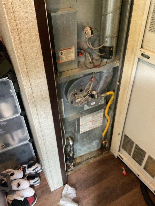 Responded to no cooling complaint on residential air conditioning system. Upon arrival, found complete system failure with no cooling throughout home. Performed diagnostic evaluation of both indoor air handler and outdoor condensing unit. 

Inspection of outdoor unit revealed heavily corroded service valves and refrigerant line connections showing significant age-related deterioration. Service port fittings displayed extensive rust and corrosion. Insulation on refrigerant lines showed advanced degradation, particularly on suction line with black foam insulation completely deteriorated. Connected manifold gauges to service ports to assess system pressures.

System evaluation indicated critically low refrigerant charge consistent with customer's initial concern regarding possible leak. Visual inspection confirmed multiple potential leak points at corroded valve connections and deteriorated line set components. Given the advanced age of equipment (10+ years), extensive corrosion on servic