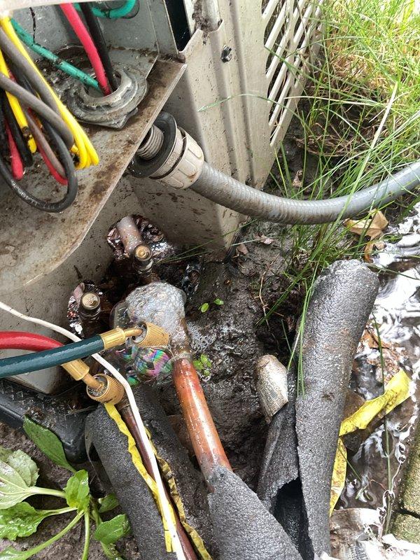 Responded to no cooling complaint on residential air conditioning system. Upon arrival, found complete system failure with no cooling throughout home. Performed diagnostic evaluation of both indoor air handler and outdoor condensing unit. 

Inspection of outdoor unit revealed heavily corroded service valves and refrigerant line connections showing significant age-related deterioration. Service port fittings displayed extensive rust and corrosion. Insulation on refrigerant lines showed advanced degradation, particularly on suction line with black foam insulation completely deteriorated. Connected manifold gauges to service ports to assess system pressures.

System evaluation indicated critically low refrigerant charge consistent with customer's initial concern regarding possible leak. Visual inspection confirmed multiple potential leak points at corroded valve connections and deteriorated line set components. Given the advanced age of equipment (10+ years), extensive corrosion on servic