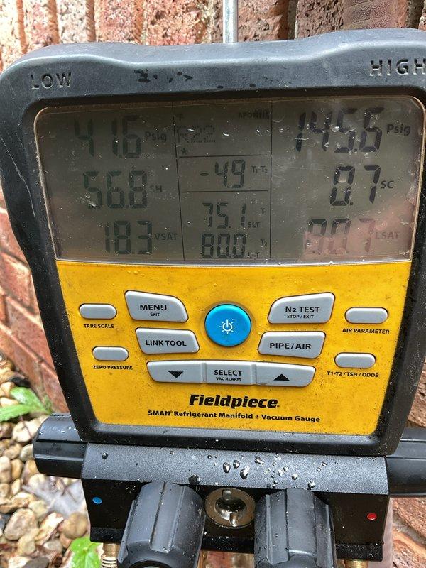 Responded to no cooling complaint with system running but not cooling and weak airflow. Upon inspection, found evaporator coil severely iced over due to restricted airflow and evidence of refrigerant system issues. Manifold gauge readings confirmed low suction pressure at 18.3 PSI with abnormal temperature differentials. Observed heavily corroded copper refrigerant lines with deteriorated insulation and significant moisture intrusion at outdoor unit connections. System exhibited classic symptoms of low refrigerant charge combined with restricted airflow across evaporator coil. Documented equipment condition with photos showing extensive frost accumulation on suction line and corroded piping requiring attention.