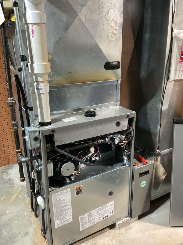 Completed comprehensive furnace and air conditioning clean and check maintenance service. Inspected and serviced all internal components including blower motor, electrical connections, and mechanical assemblies with access panel removed for thorough evaluation. Delivered and installed three replacement water filters for the residential water filtration system, ensuring proper operation of the blue housing unit with brass fittings and shut-off valves.