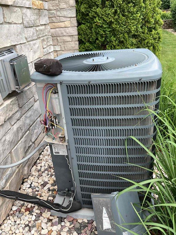 # HVAC Service Completed

Responded to no cooling complaint on residential air conditioning system. Upon arrival, performed diagnostic evaluation of outdoor condensing unit. Testing revealed locked rotor condition in compressor, indicating complete compressor failure. Compressor motor would not turn and showed no electrical continuity through windings.

Confirmed compressor replacement required due to mechanical seizure. Unit is under warranty coverage. Documented equipment condition with photographs showing outdoor condensing unit installation, electrical connections, and overall system configuration. Electrical disconnect and wiring connections inspected and photographed for warranty claim documentation.

Provided customer with diagnosis of locked compressor requiring full compressor replacement under existing warranty terms. Equipment awaiting warranty approval for compressor replacement to restore cooling operation.