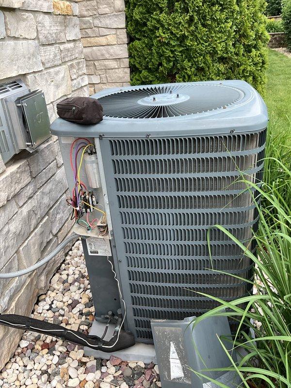# HVAC Service Completed

Responded to no cooling complaint on residential air conditioning system. Upon arrival, performed diagnostic evaluation of outdoor condensing unit. Testing revealed locked rotor condition in compressor, indicating complete compressor failure. Compressor motor would not turn and showed no electrical continuity through windings.

Confirmed compressor replacement required due to mechanical seizure. Unit is under warranty coverage. Documented equipment condition with photographs showing outdoor condensing unit installation, electrical connections, and overall system configuration. Electrical disconnect and wiring connections inspected and photographed for warranty claim documentation.

Provided customer with diagnosis of locked compressor requiring full compressor replacement under existing warranty terms. Equipment awaiting warranty approval for compressor replacement to restore cooling operation.
